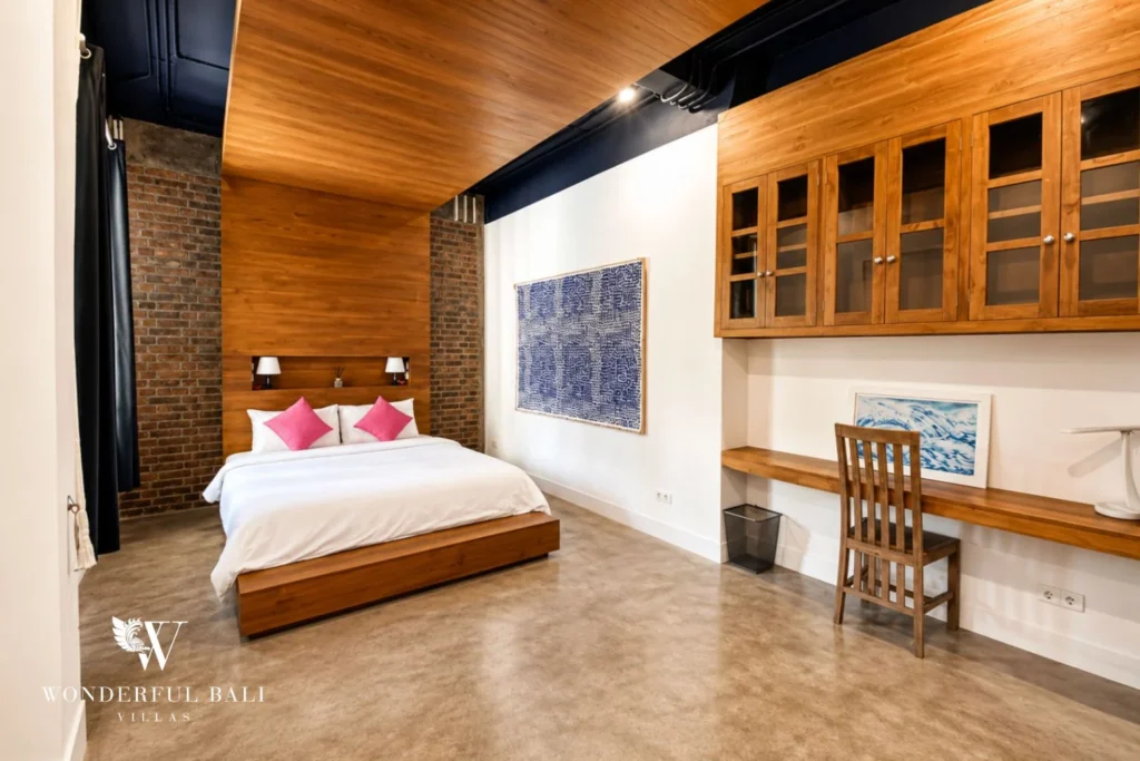 Walk-in wardrobe with timber cabinetry and built-in desk at villa in Umalas, Bali