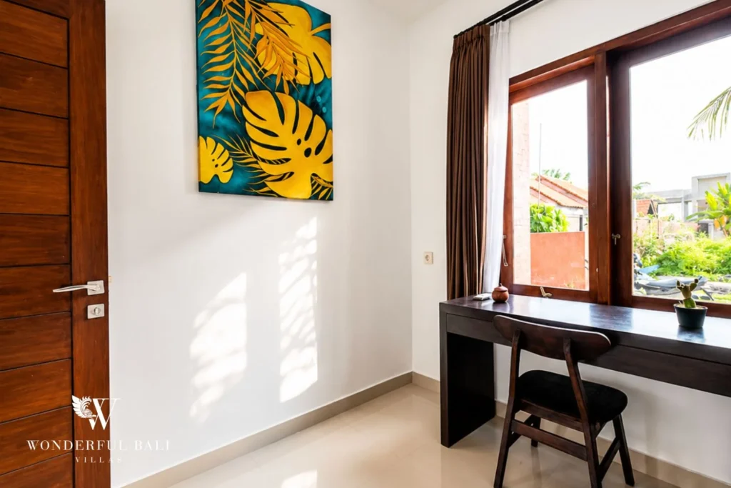Workspace nook with batik artwork and garden view in Nyanyi, Bali