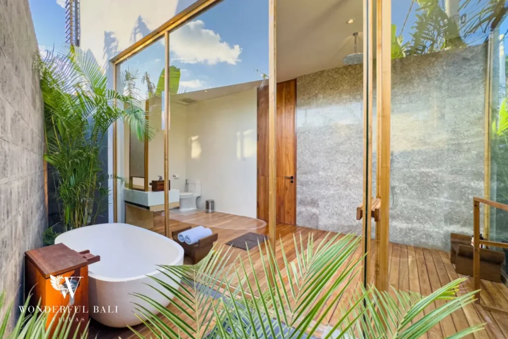 Bathroom with freestanding tub and garden view at villa in Umalas, Bali