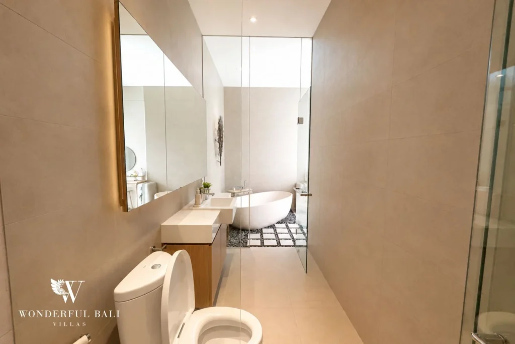 En-suite bathroom with vanity and mirror at villa in Petitenget, Bali