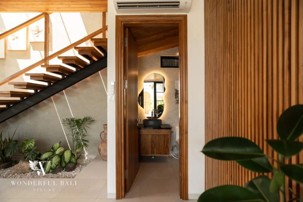Corridor with timber staircase and vanity at villa in Umalas, Bali