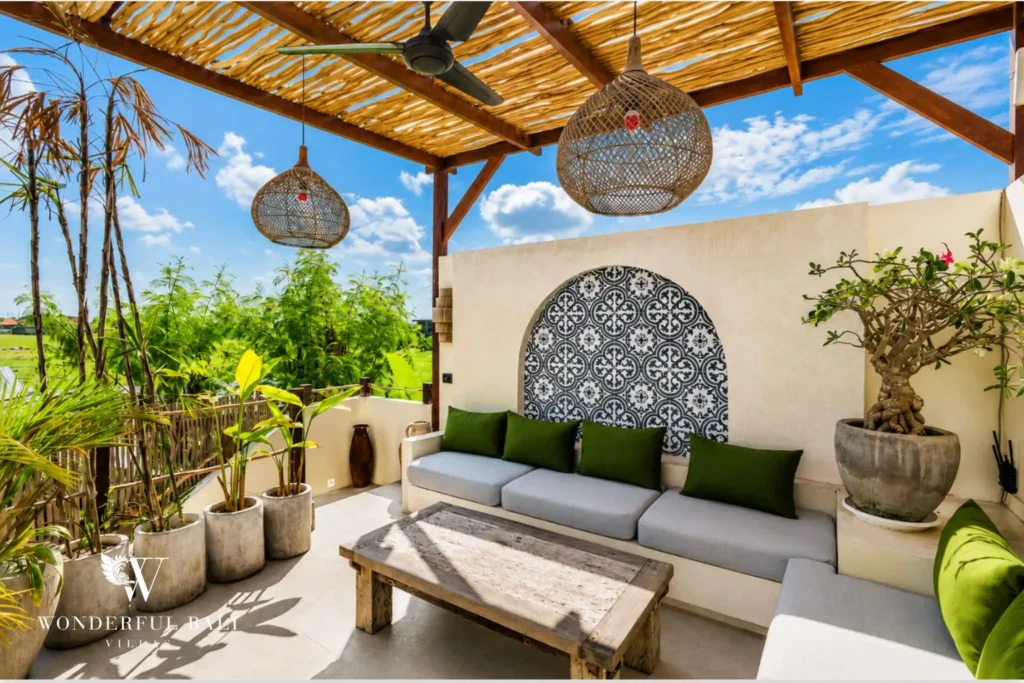 Open terrace with sofa and patterned tile under a bamboo roof at villa in Seseh, Bali