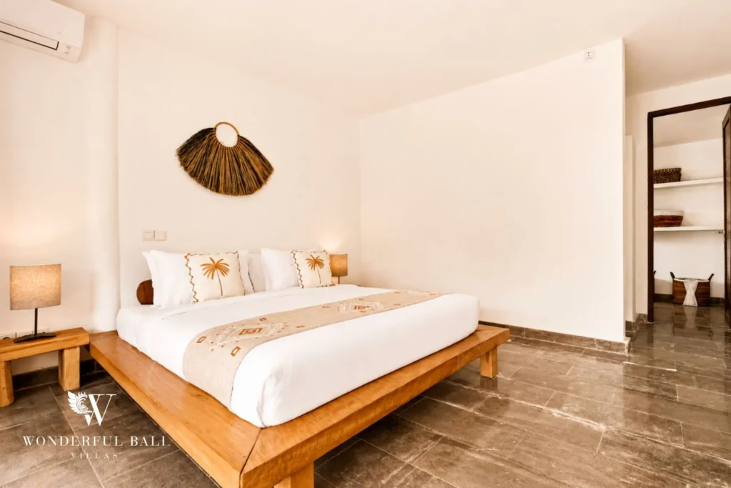 Bedroom with white bed and minimal white walls at villa in Umalas, Bali