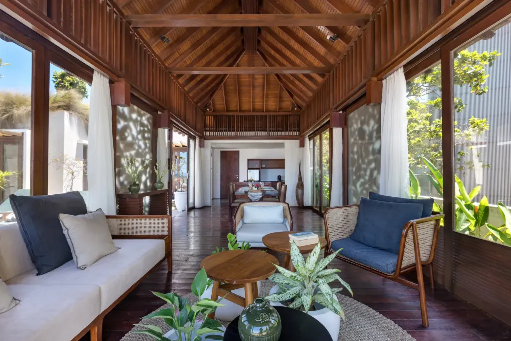Living area with yellow sofa and timber ceiling at villa in Batu Belig, Bali