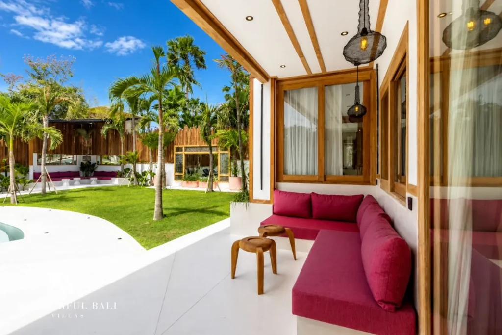 Outdoor terrace with daybed and garden view at family villa in Umalas, Bali