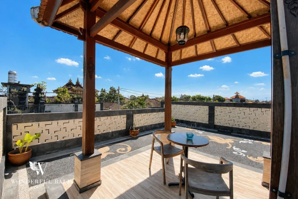 Rooftop gazebo with woven bamboo ceiling and dining table at villa in Canggu, Bali
