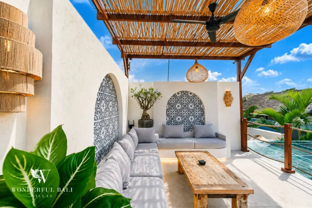 Terrace lounge with arched patterned tile and rice-field view at villa in Seseh, Bali