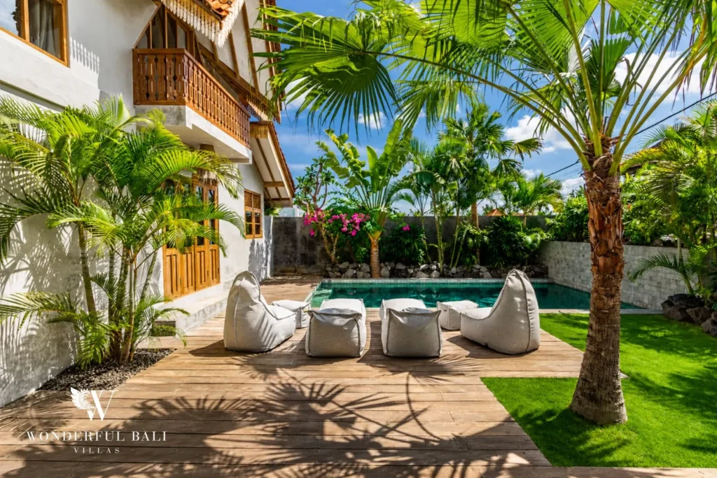 Tropical garden with pool and palm tree at a villa in Canggu, Bali