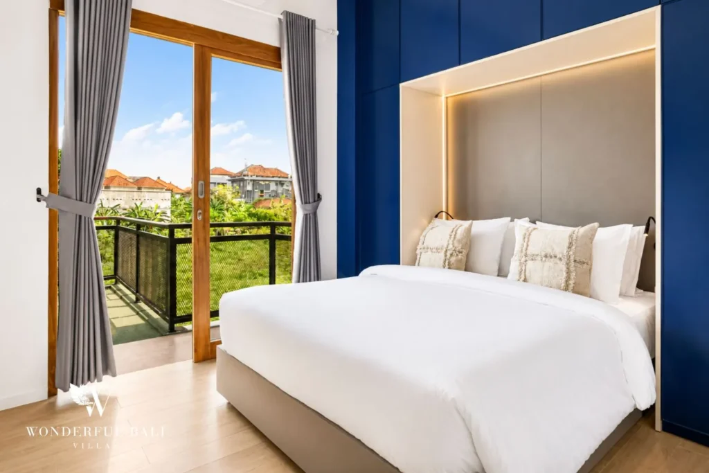 Bathroom with blue finish, walk-in shower and toilet at villa in Denpasar, Bali