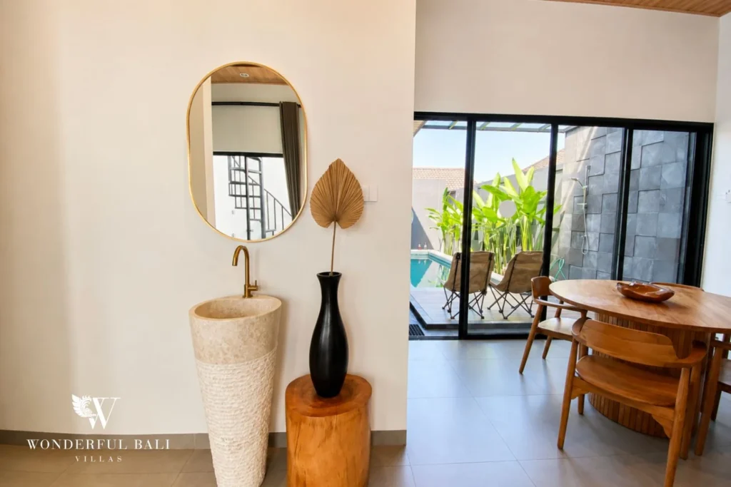 Entry hall with carved sandstone sink at villa in Canggu, Bali