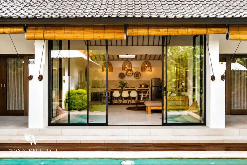 Villa facade with sliding doors opening to the living area and pool at villa in Umalas, Bali