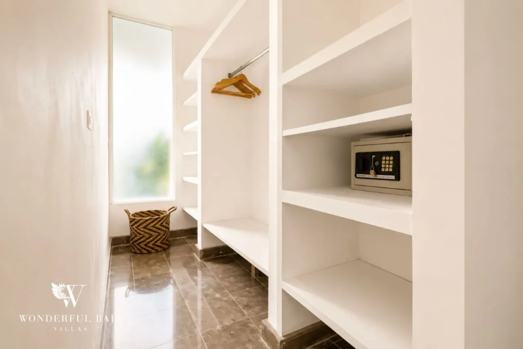 Walk-in wardrobe with built-in timber shelving at villa in Umalas, Bali