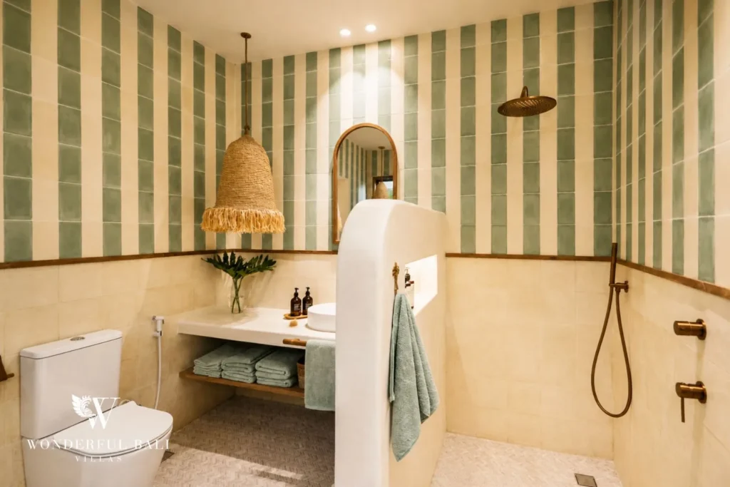 Bathroom with green-striped walls, vanity and walk-in shower at villa in Berawa, Bali