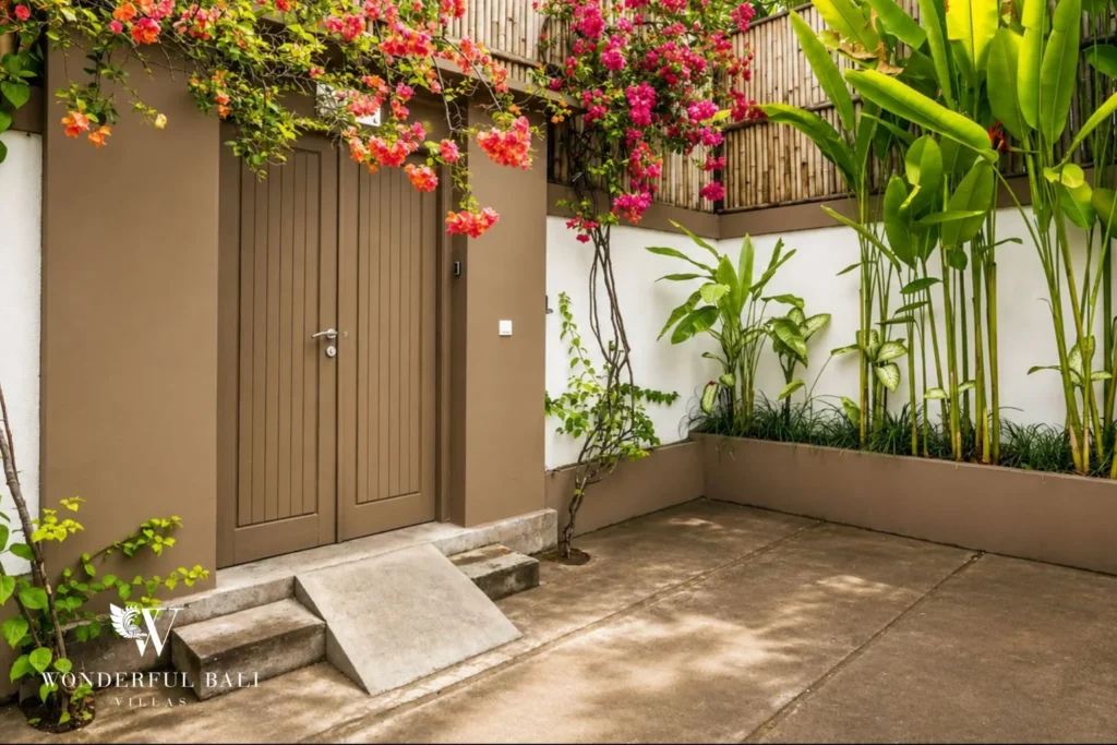 Villa entrance gate with bougainvillea and tropical planting at villa in Umalas, Bali