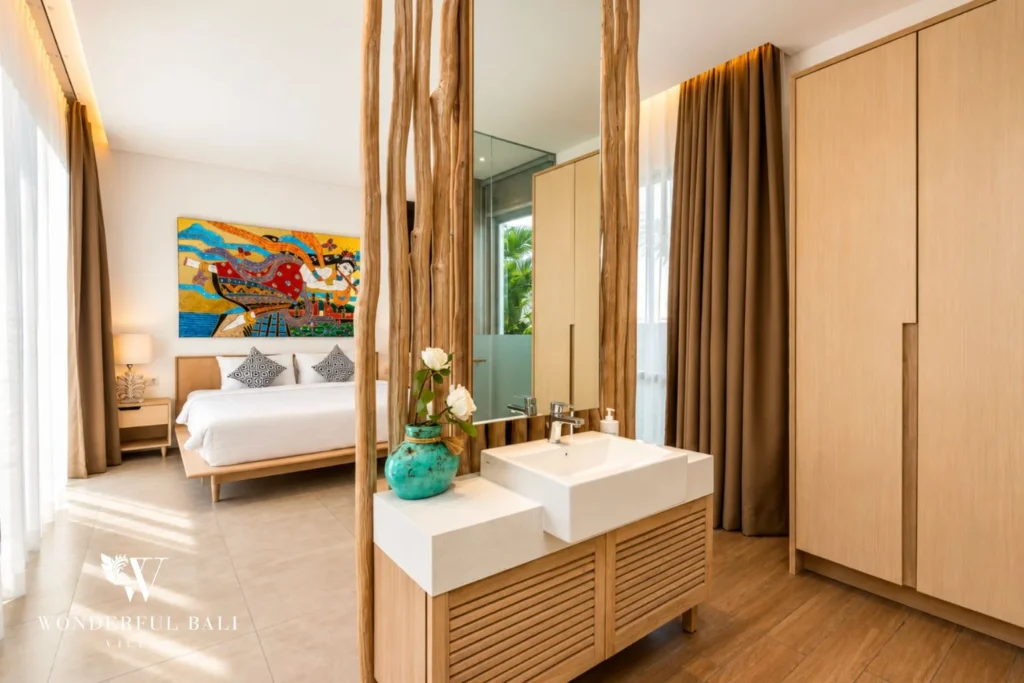 Bedroom with king bed and en-suite double vanity at villa in Petitenget, Bali