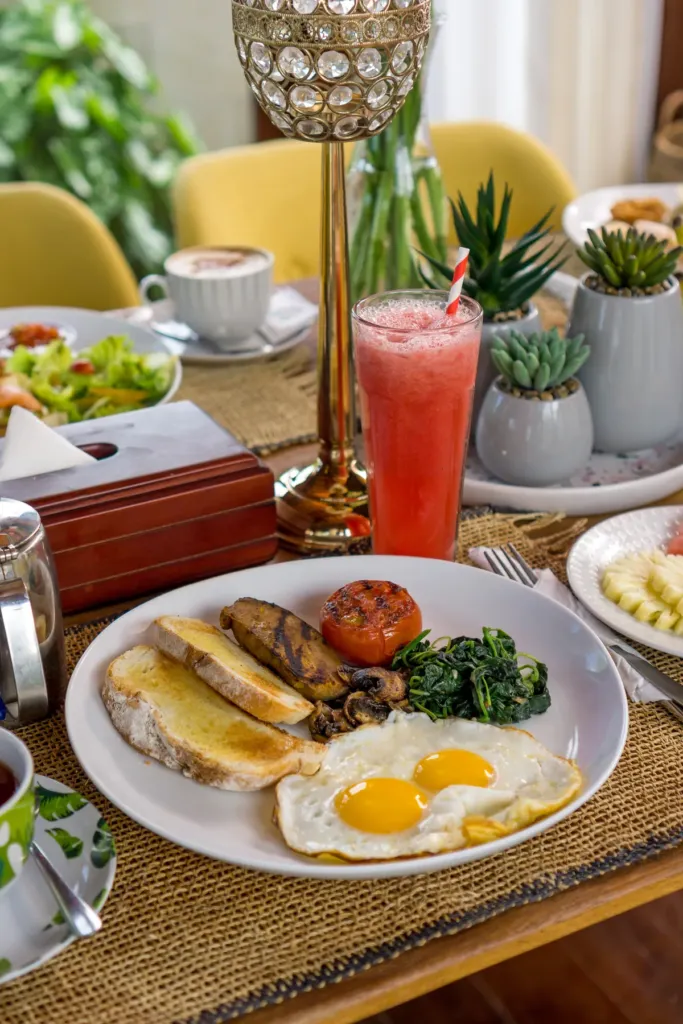 Breakfast spread with tropical fruit and juice at villa in Batu Belig, Bali