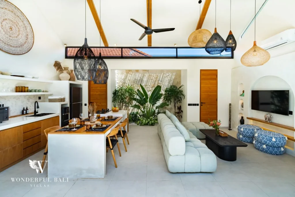 Open kitchen and living with island and white sofa at villa in Seseh, Bali