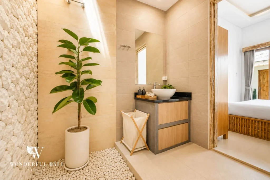 Bathroom with timber vanity, potted plant and mirror at villa in Canggu, Bali