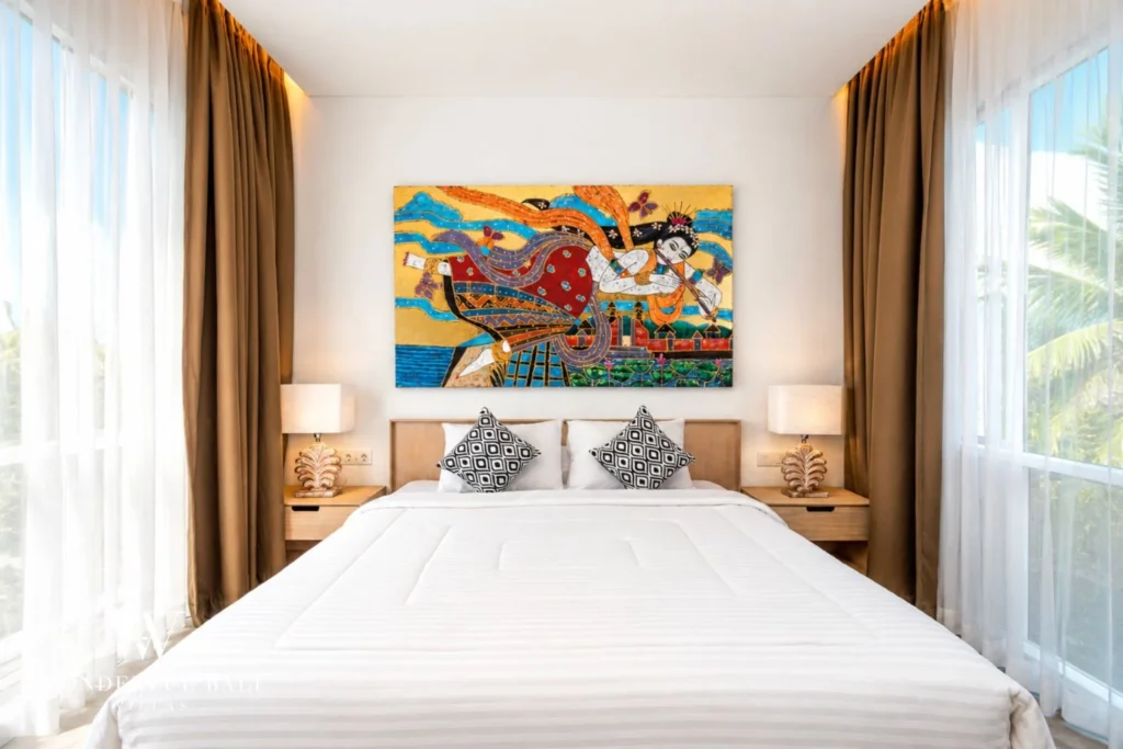 Bedroom with king bed and large colourful artwork at villa in Petitenget, Bali