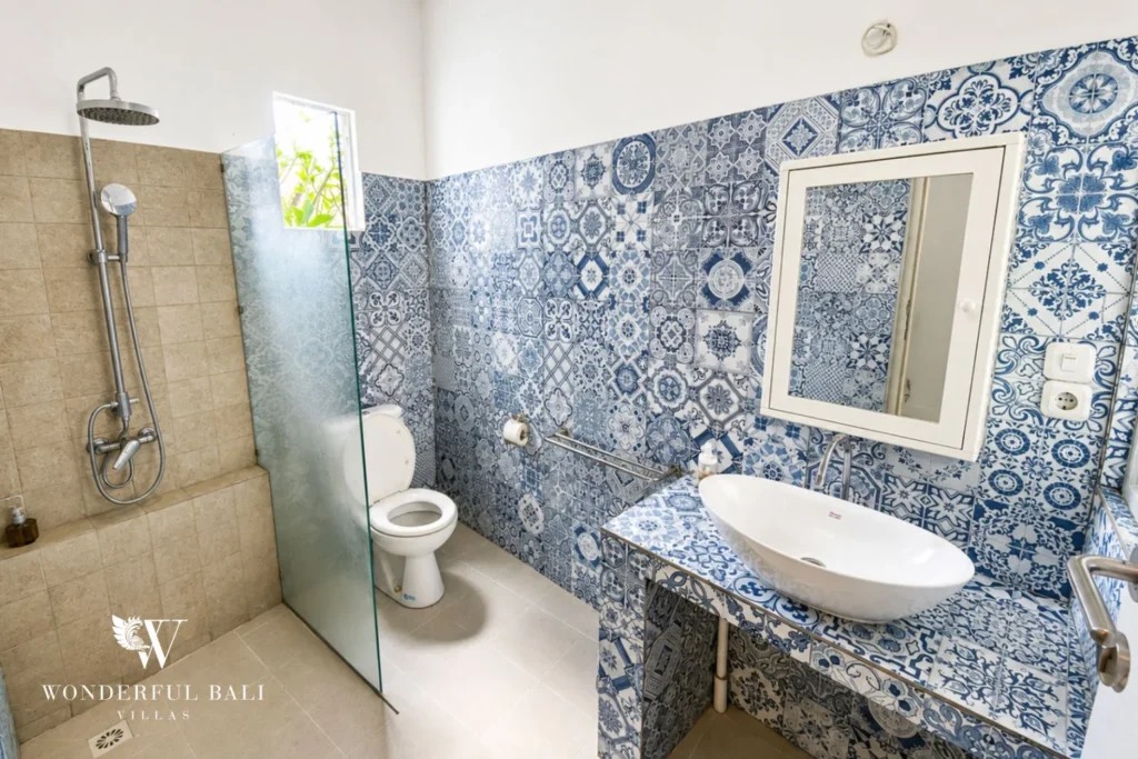 Bedroom with king bed, balcony and contemporary face artwork at villa in Umalas, Bali