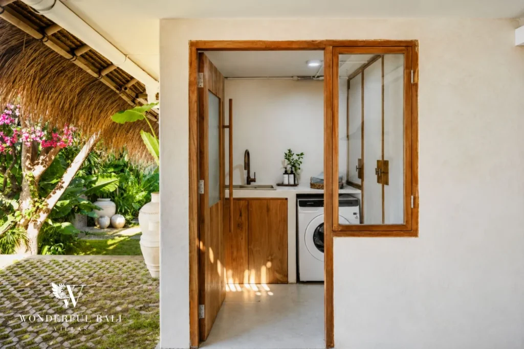 Bedroom and dressing area through an arched doorway at villa in Berawa, Bali