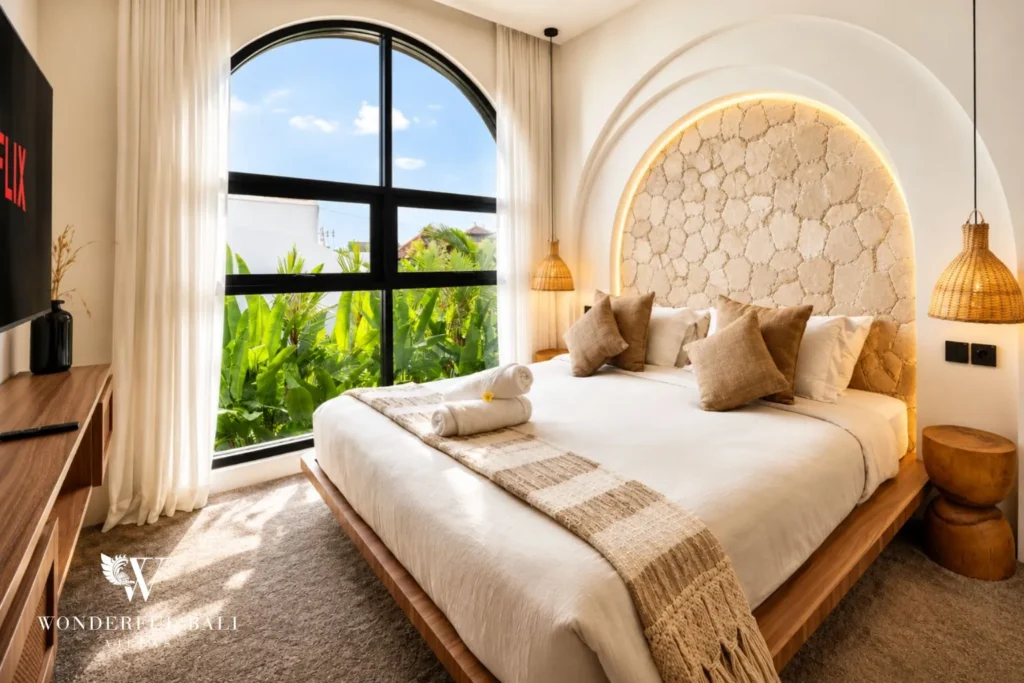 Bathroom with arched vanity and round mirror at villa in Umalas, Bali