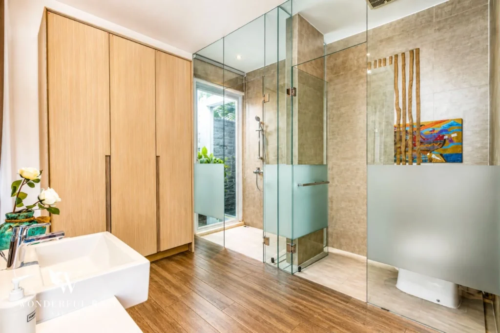 En-suite bathroom with walk-in glass shower at villa in Petitenget, Bali