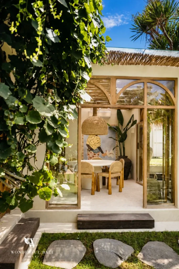Outdoor bathroom and shower framed by climbing plants at villa in Berawa, Bali
