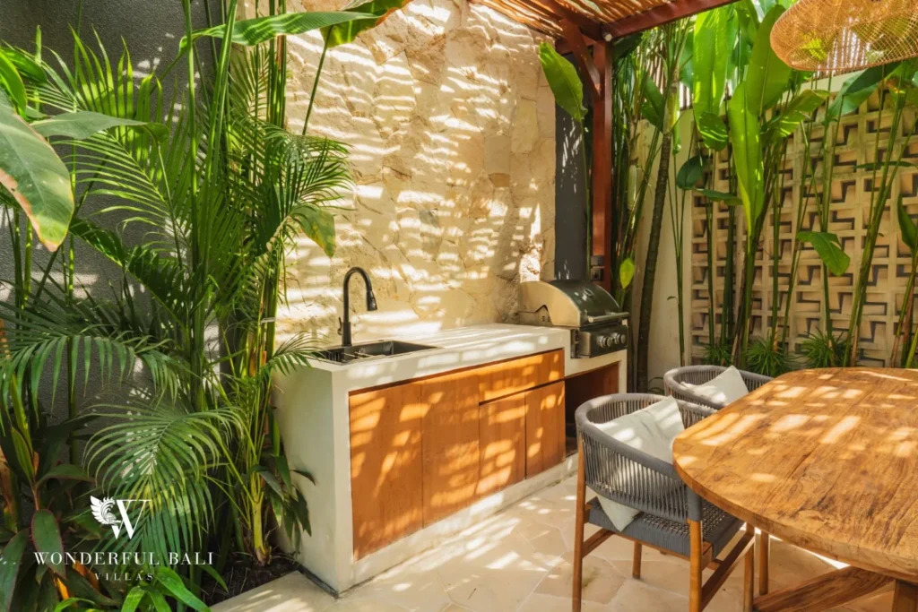 Bathroom with terrazzo vanity and tropical plants at villa in Seseh, Bali