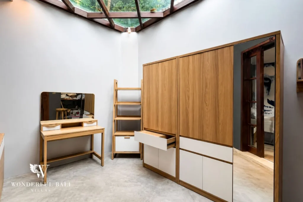 Bedroom with wall TV and built-in timber wardrobe at villa in Umalas, Bali
