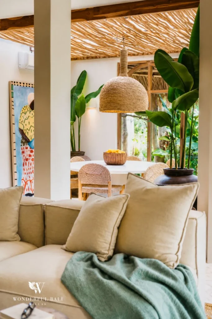 Living lounge with sofa, high ceiling and large plant at villa in Berawa, Bali
