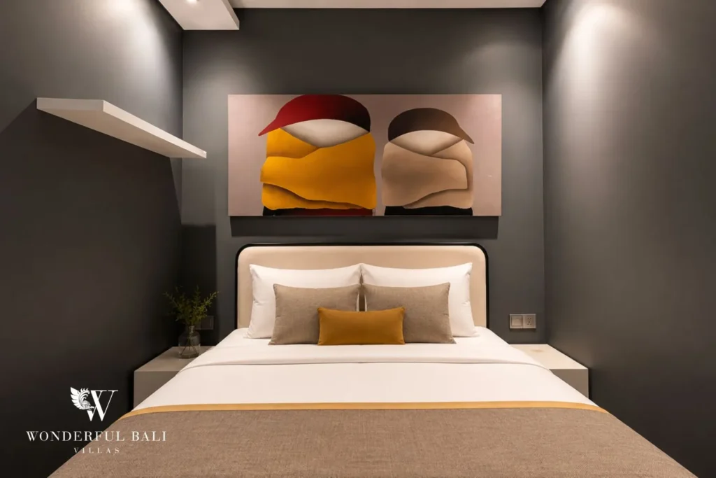 Bedroom with rounded yellow headboard against a grey wall at villa in Umalas, Bali