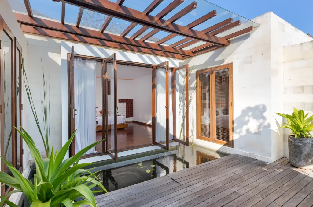 Bedroom opening to a tropical garden at villa in Batu Belig, Bali
