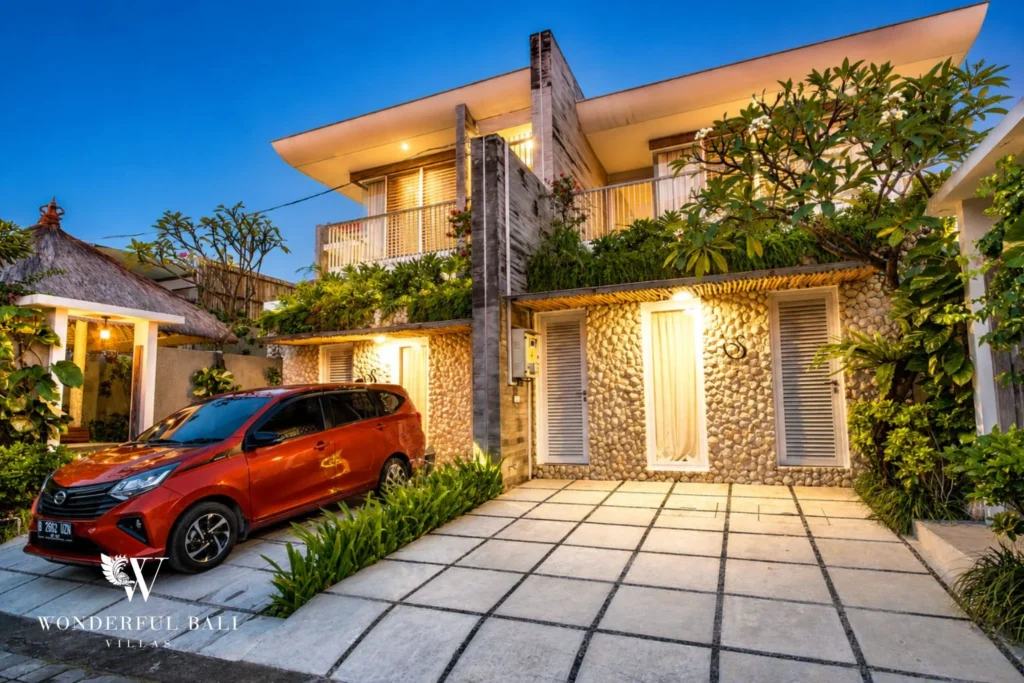 Villa exterior and terrace lit at dusk in Petitenget, Bali