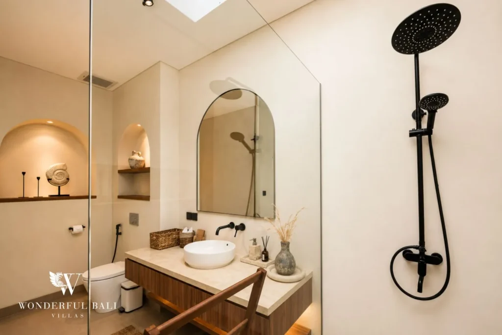 Bathroom vanity with arched mirror and lamp at villa in Umalas, Bali