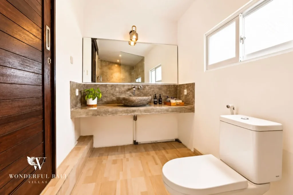 Bathroom with vessel basin, timber vanity and mirror at villa in Umalas, Bali