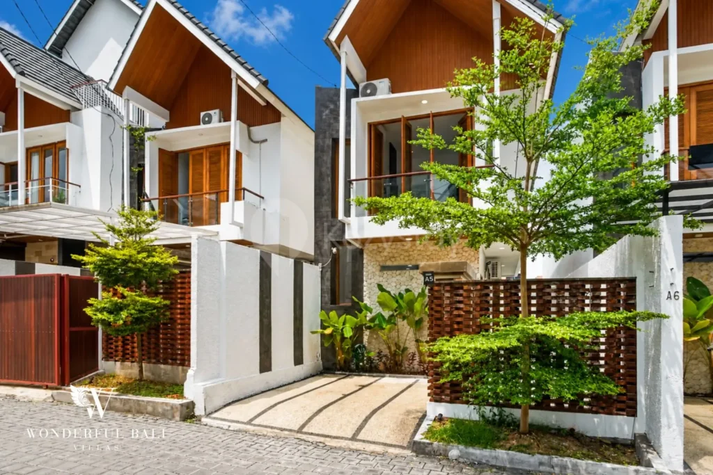 Cluster of townhouse villas with pitched roofs and garden pathway in Denpasar, Bali