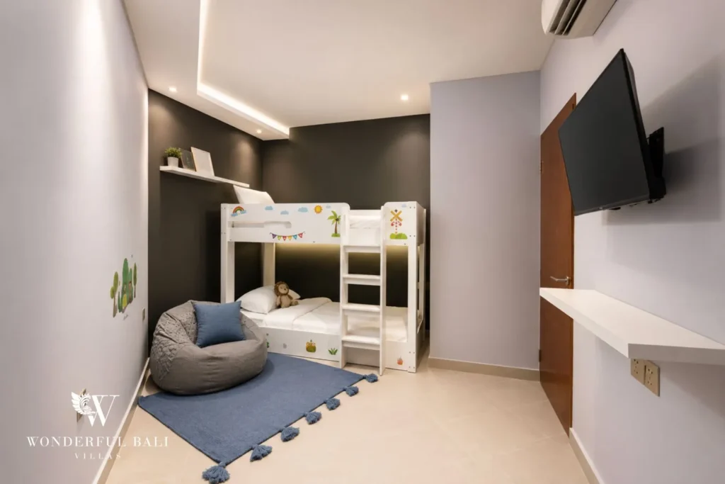 Kids' bunk room with bunk beds and beanbag at villa in Umalas, Bali