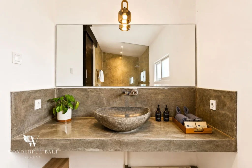 Bathroom with stone vessel basin on a concrete vanity at villa in Umalas, Bali