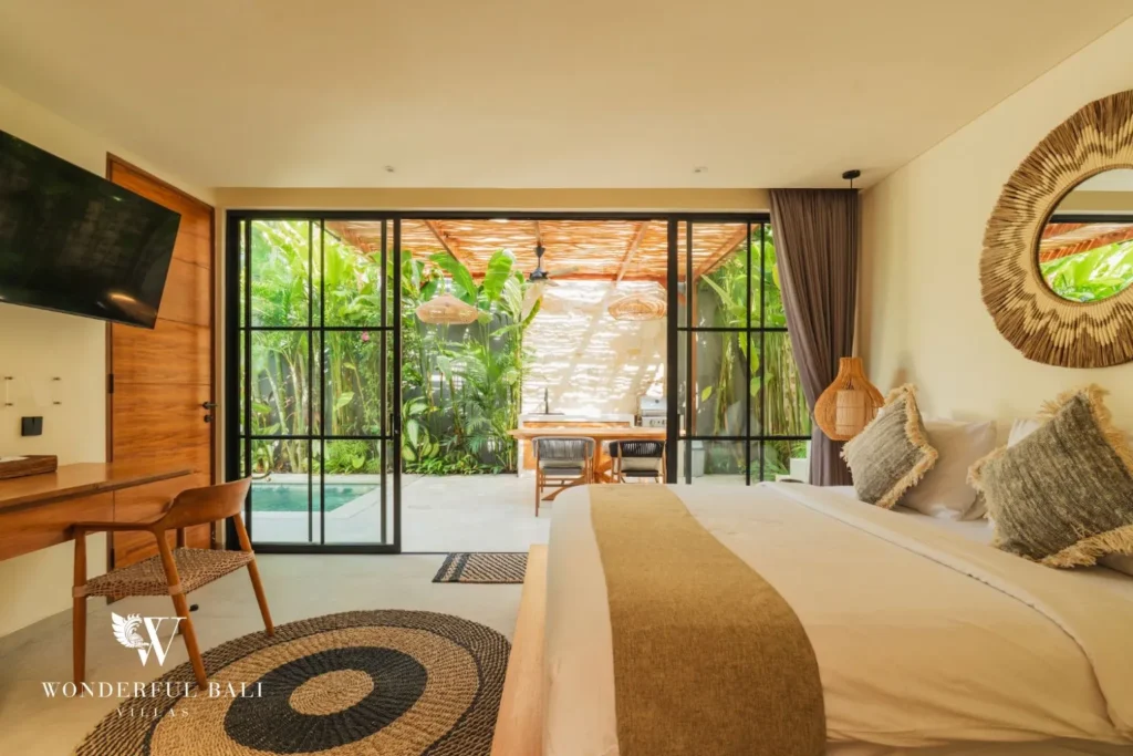 Bedroom with bed, TV and garden view at villa in Seseh, Bali