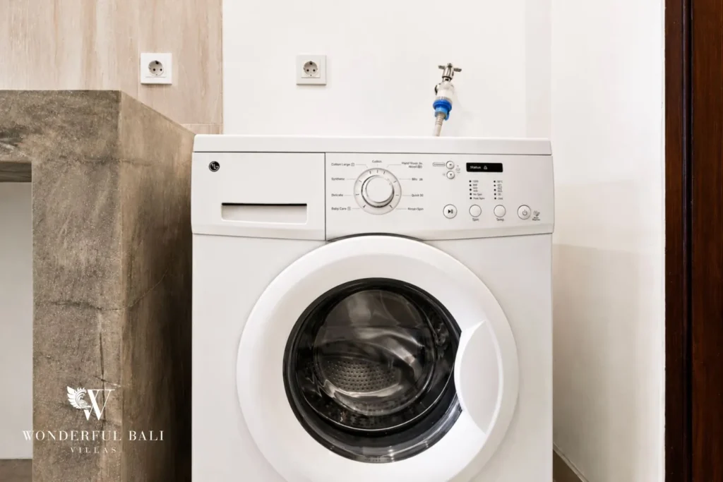 Laundry area with washing machine at villa in Umalas, Bali