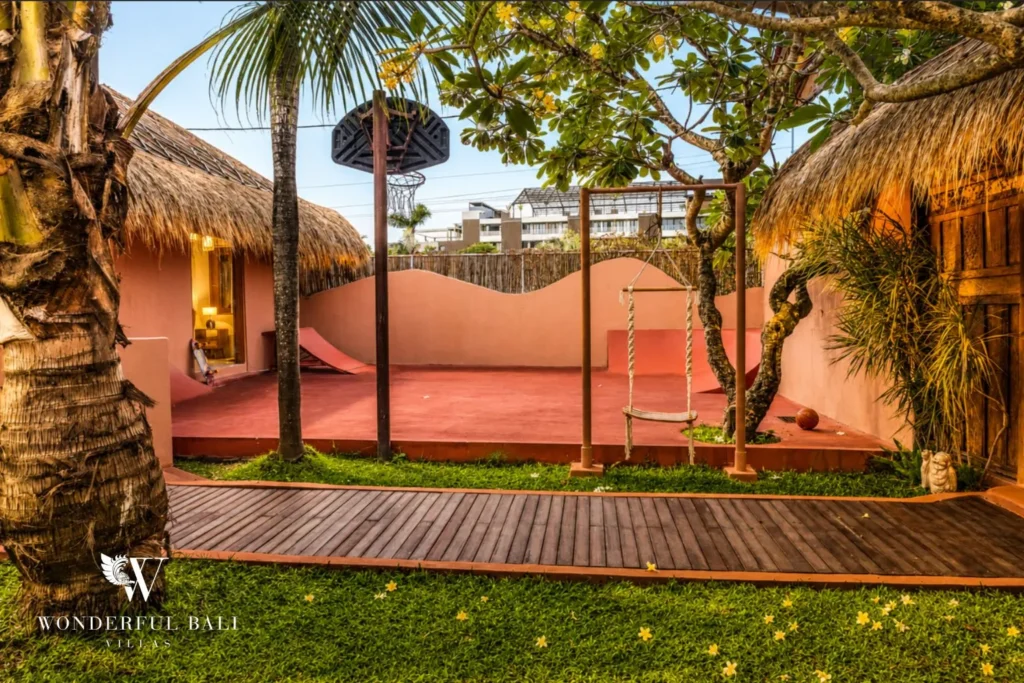 Outdoor terrace with terracotta walls and timber deck at villa in Bumbak, Bali