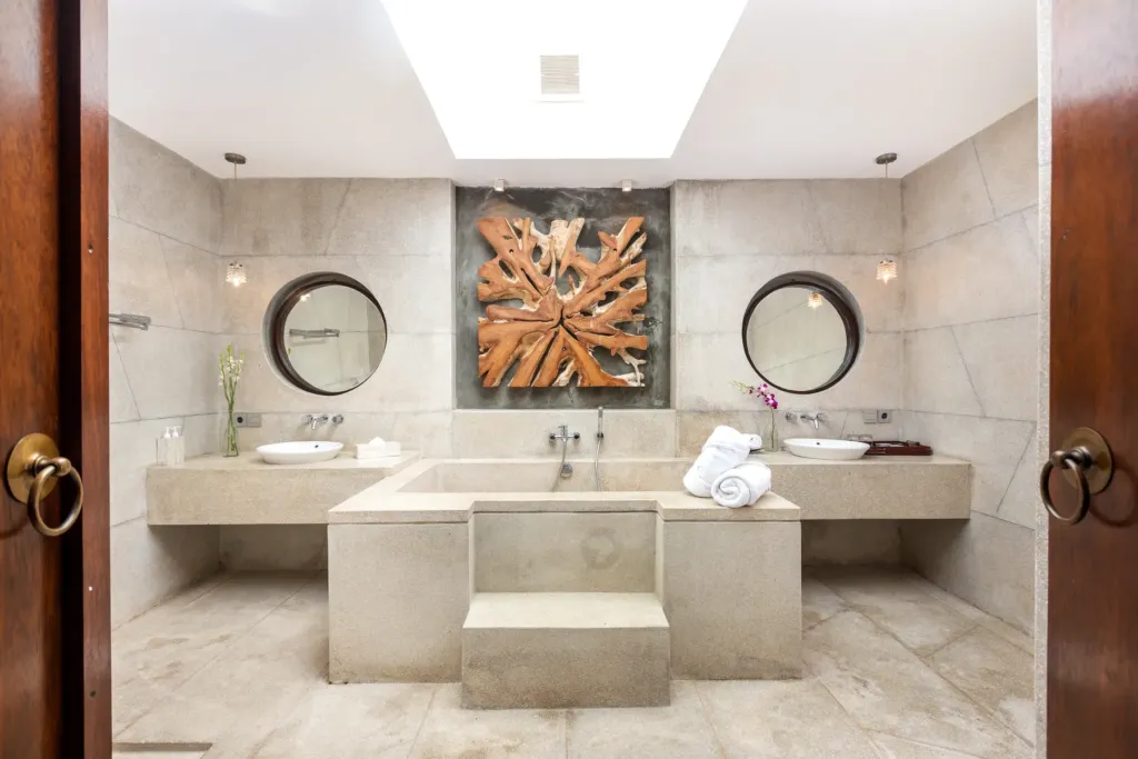 Bathroom with carved panel and walk-in shower at villa in Batu Belig, Bali