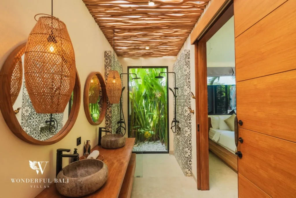 Bathroom and dressing area with vessel basin and timber finishes at villa in Seseh, Bali
