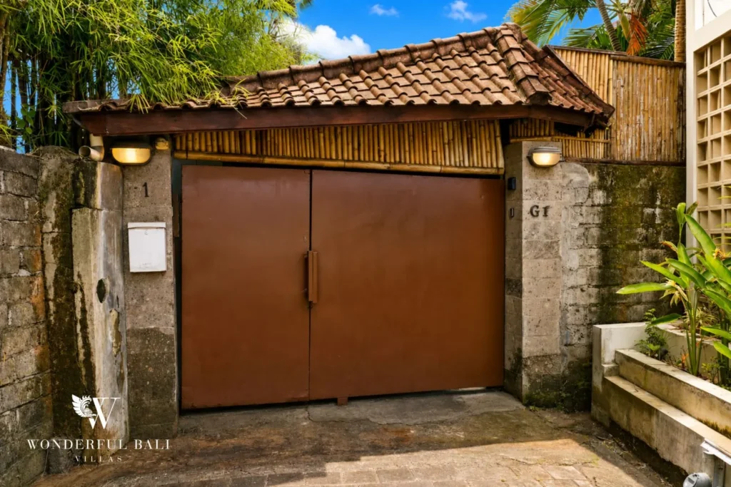 Timber entrance gate with traditional tiled roof at villa in Umalas, Bali