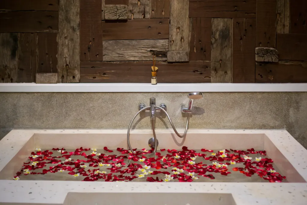Bathtub with rose-petal decor at villa in Batu Belig, Bali