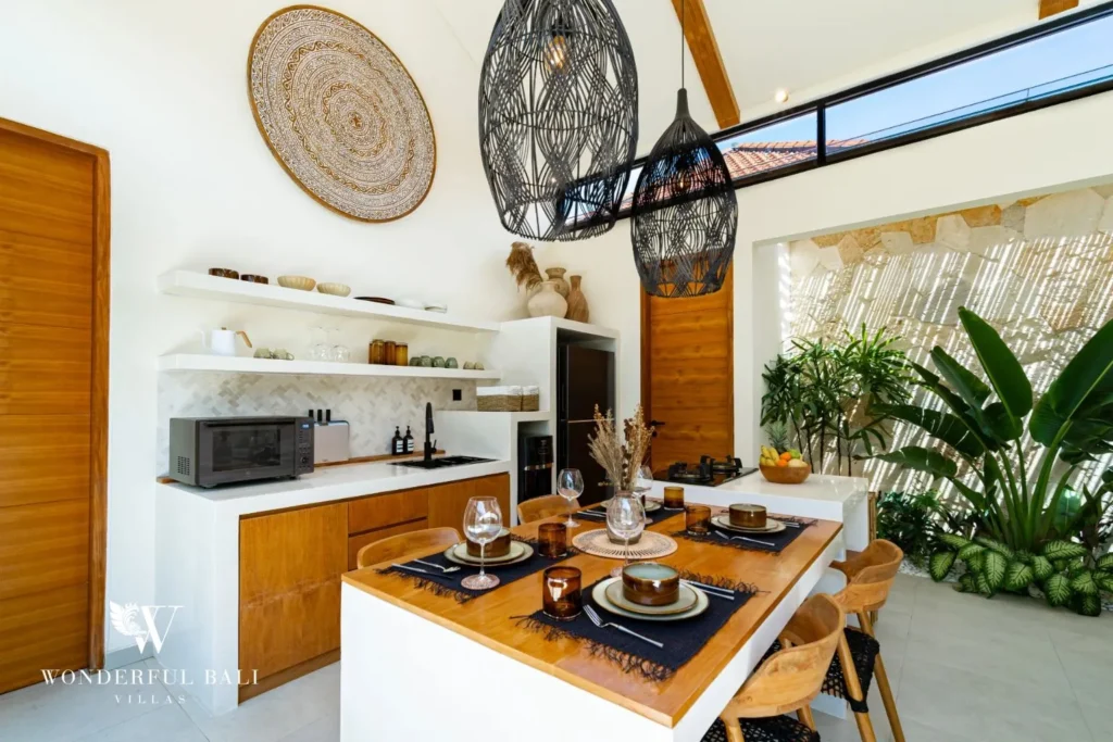 Kitchen bar with woven wall decor and plants at villa in Seseh, Bali