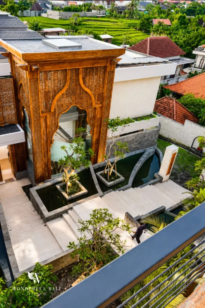 Outdoor courtyard with timber daybed and plants at villa in Umalas, Bali