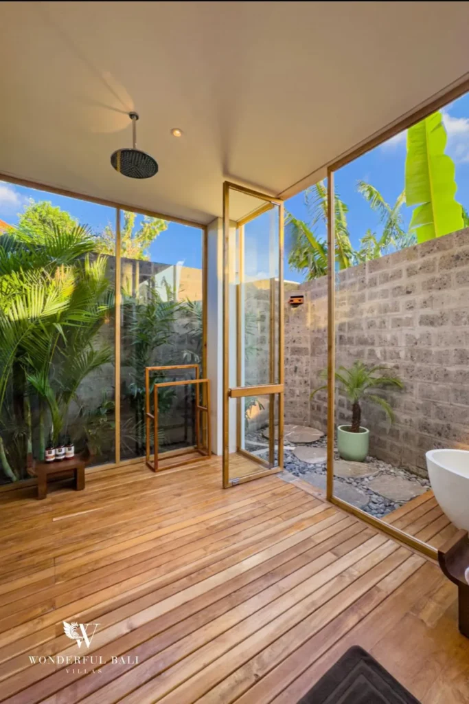 Outdoor shower with blue tile and plants at villa in Umalas, Bali