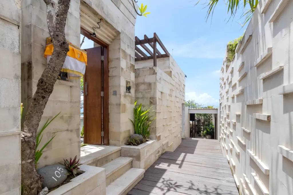 Stone entrance pathway with tropical planting at villa in Batu Belig, Bali